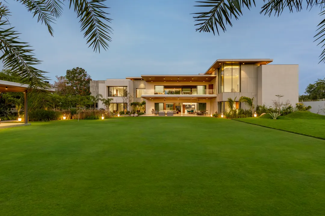 A big house across its lawn at dusk.
