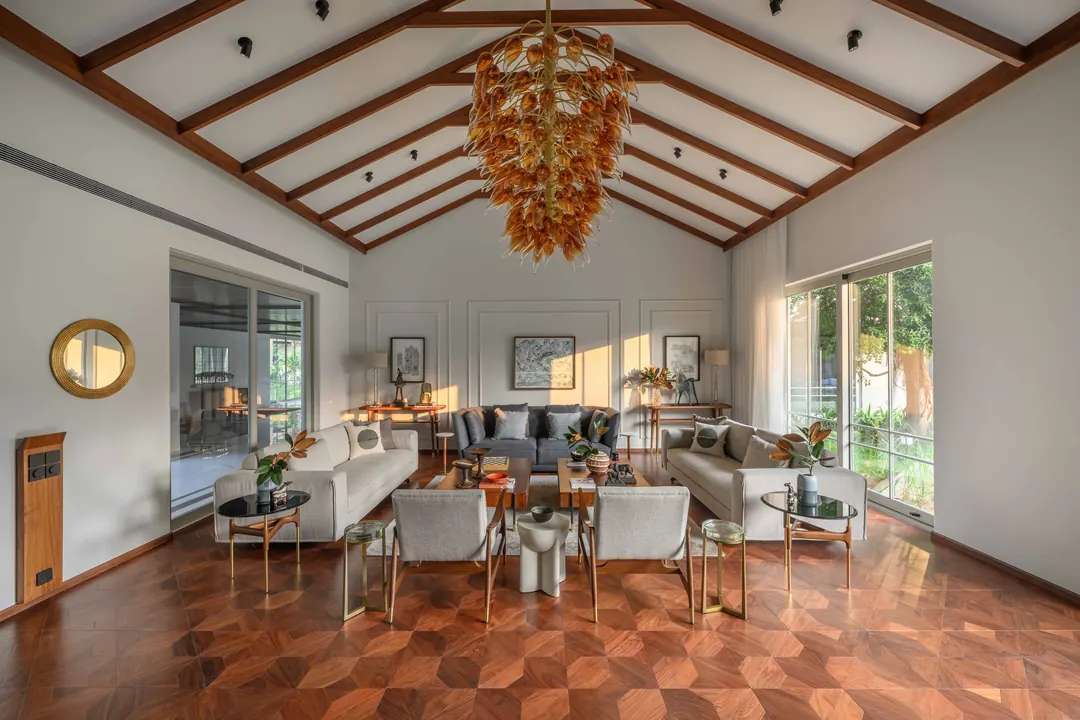 A vaulted living room with a glass chandelier.
