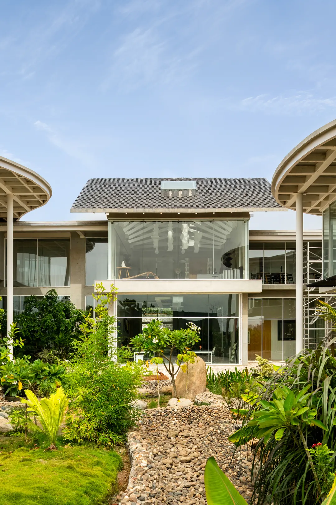 Oxygen, the studio: its curved roof and glass walls above the garden.